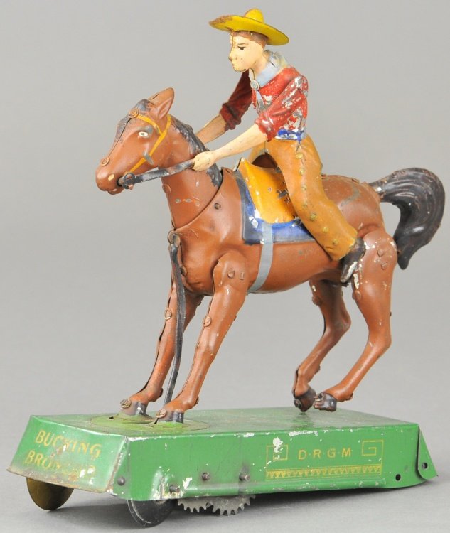 LEHMANN BUCKING BRONCO: Germany, brown horse version, hand painted with tin litho base, clockwork mechanism allows rider to seemingly buck off the horse's saddle. 6 1/2" l.