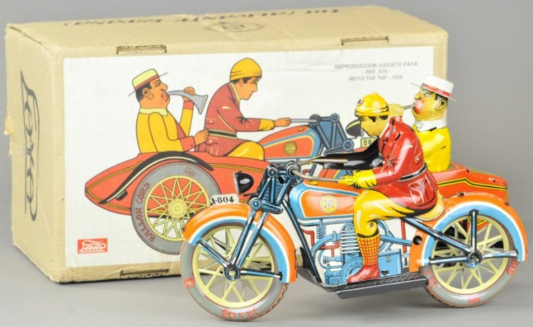 PAYA BOXED TUT TUT W/MOTORCYCLE SIDE CAR: Spain, Contemporary edition, made in 1990, lithographed tin, whimsical cycle with side car, seated figure blowing horn, key wind mechanism. 11" l.