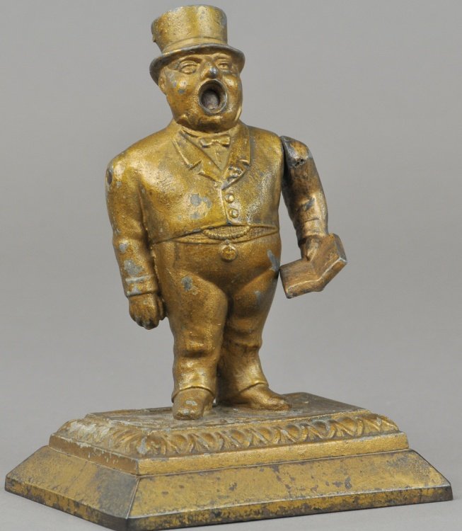 TOWN CRIER CIGAR CUTTER: Full figure die cast depiction of town crier, as arm is pulled down, mouth area reveals the cigar cutting blade. 7 1/2" h.