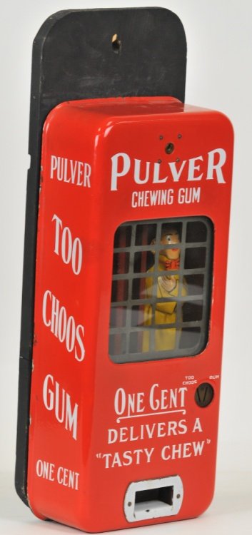 PULVER CHEWING GUM WALL MOUNT MACHINE: Brilliant red porcelain Pulver "Too Choos Gum" and "Joy Mint Gum," one cent delivers a tasty chew, tin yellow kid turns when a penny is inserted, mounted on wood, ready to hang, two keys for machine.