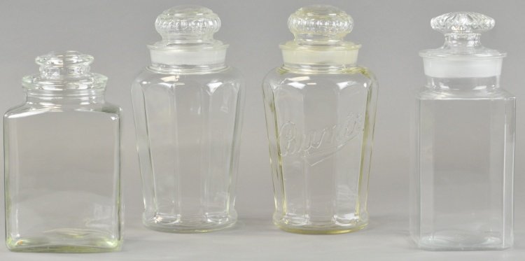 FOUR COUNTRY STORE CANDY JARS: A multi side "Bunte" candy jar, a nine sided store jar and four panel side jar, all with clean ground tops and a Ganner Glass Works candy jar. 10" to 12".