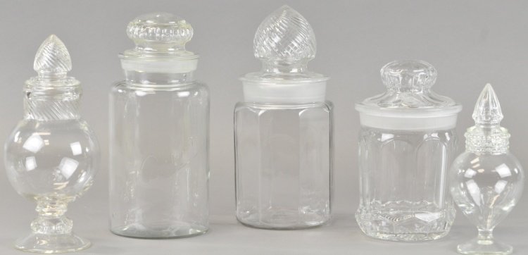 FIVE COUNTRY STORE SHOW JARS: Three candy jars with ground tops, minor edge wear and two bulbous jars with swirl spear tops, an attractive grouping in very clean condition. 9" to 12".