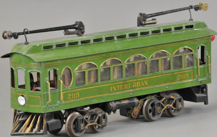 VOLTAMP No. 2115 INTERURBAN: C. 1910, early version with rear mounted drum reverse and sprung arch trucks, motor and wiring intact but not tested, light olive tin body, wood floor, cast iron painted pilots, interior complete with