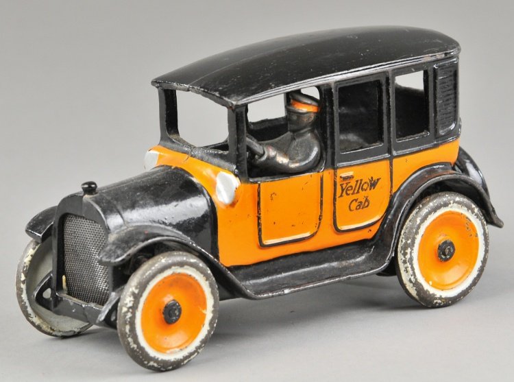ARCADE YELLOW CAB: Cast iron, very popular toy cab painted in orange and black colors, sides read Yellow Cab, painted disc wheels, seated electroplated driver and cast spare on rear. 7 3/4" l.