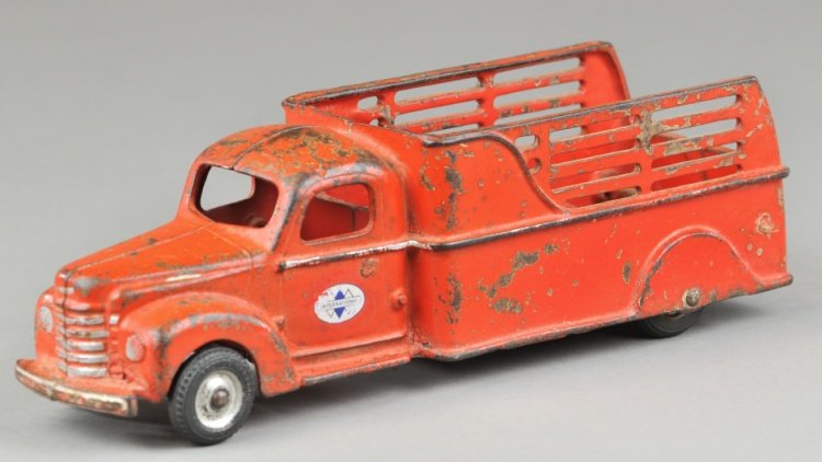 1941 INTERNATIONAL STAKE TRUCK: Arcade, cast iron, painted in red overall, painted in IH decals on doors, open stake body, enclosed cab, black rubber tires. 11 1/2" l.