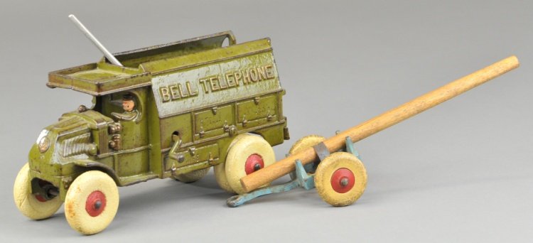 HUBLEY BELL TELEPHONE TRUCK: Cast iron, painted in olive green, typical extensive detail to open body embossing, body contains nickel ladders, shovels and pole carrier, rubber tires, spare on rear. 9 1/2" l.