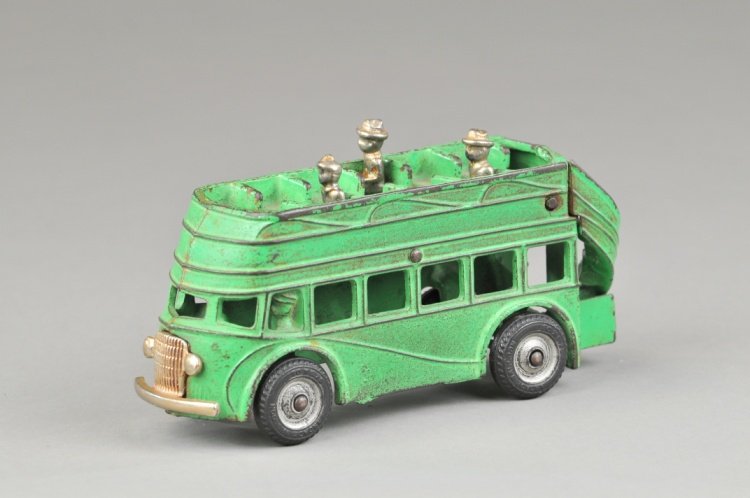 DOUBLE DECKER BUS: Arcade, cab over engine style, cast iron, painted in green, upper deck bench seating, rear stairs, black rubber tires, decal on side, cast driver. 8" l.