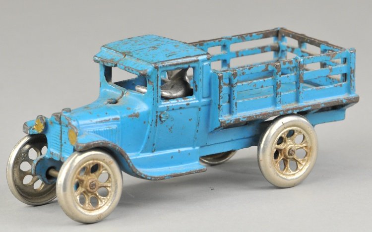 ARCADE FORD MODEL 'T' STAKE TRUCK: c. 1930, cast iron, painted in blue overall, features nickel driver and spoke wheels. 7 1/2" l.