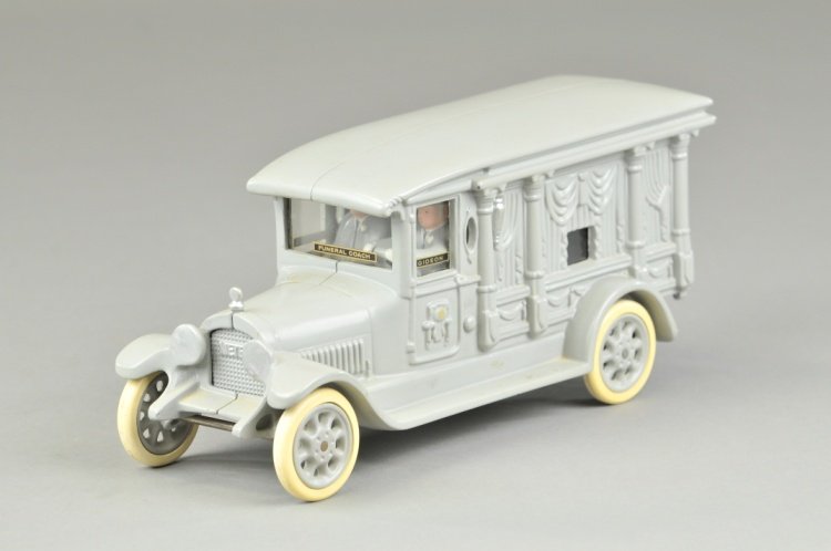 CAST IRON TOY FUNERAL CAR: Motorcade Toys, cast iron, painted in grey overall, lot includes funeral car with opening rear doors, drivers and plexi glass windows stenciled "Gideon," great casting effects. 10 1/2" l.