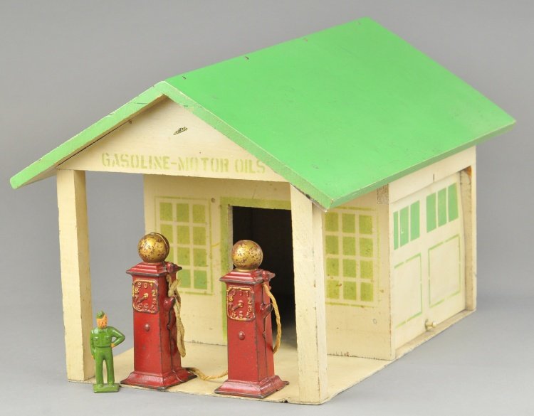 ARCADE FILLING STATION: C. 1930's, wood garage done in green roof, white sides, canopy covers two cast iron fuel pumps with embossed dials, front stenciled "Gasoline - Motor Oils," decal on gable, side bay door opens. 10" x