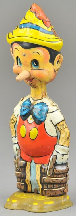 MARX PINNOCCHIO: Tin lithographed wind up walker, very colorful, pronounces tin nose makes an amusing toy depiction. 8 1/2" h.