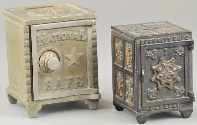 NATIONAL SAFE & SECURITY SAFE STILL BANKS: Security safe done in black with gold highlights, both cast iron with ornate molding, national safe made of cast iron and tin, both have combination doors. 4 1/4" - 4 7/8" h.