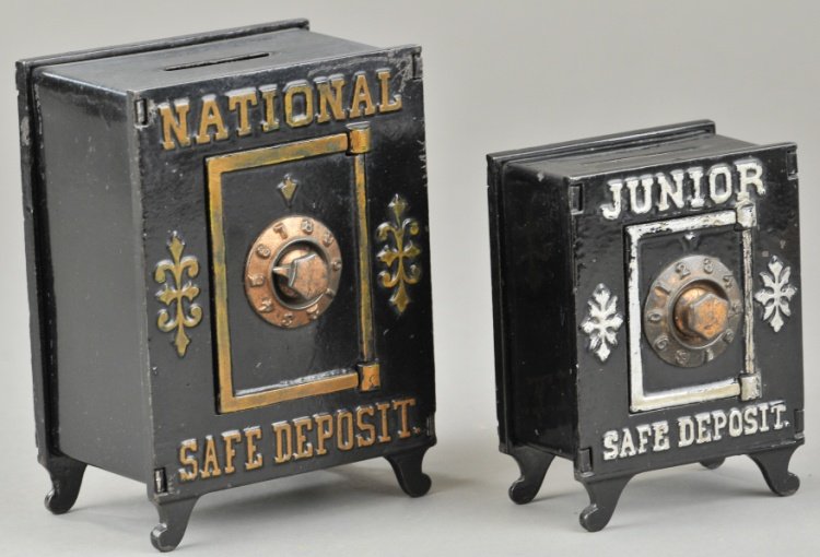 NATIONAL & JUNIOR SAFE DEPOSIT STILL BANKS: Cast iron vault safes with pressed steel money boxes, silver and gold trimmed lettering, each with combination dial door, includes Junior Safe Deposit and National Safe Deposit banks. 4 5/8" to 6" h.