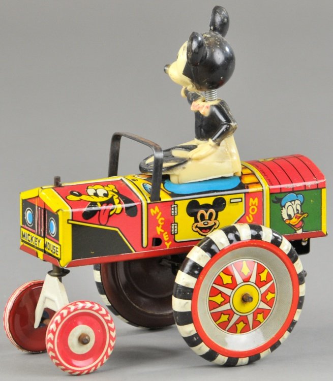 MICKEY MOUSE DIPSY CAR: Linemar, Japan, lithographed tin, very colorful, spring neck Mickey seated in open car, large disc wheels, key wind operated. 5 1/2" l.