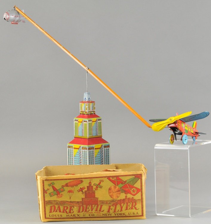 DARE DEVIL FLYER W/BOX: Louis Marx, lithographed tin skyscraper tower, support beam holds zeppelin and airplane with key wind mechanism (works but does not allow complete tower rotation because weighted zeppelin is too heavy