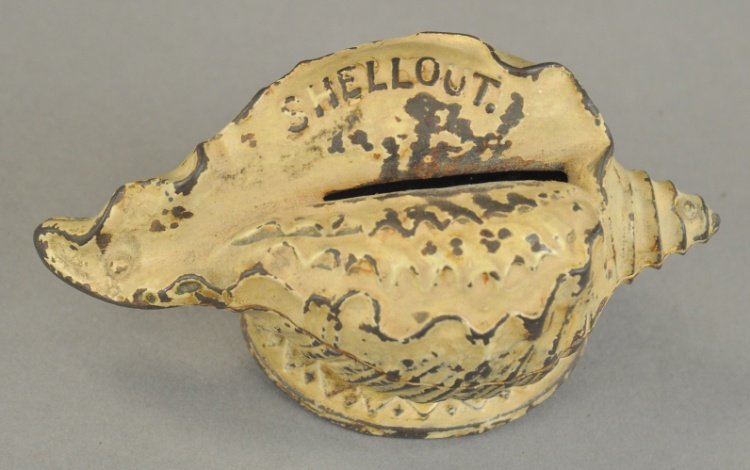 SHELL OUT STILL BANK: J&E Stevens, c. 1882, great cast iron figure of conch shell with coin slot, painted in white, scarce example. 2 1/2" h x 4 3/4" l.