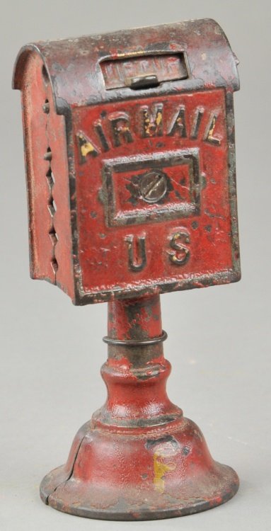 AIRMAIL BANK ON BASE STILL BANK: Dent, cast iron, painted in red overall, embossed "Air Mail US" on front, pedestal base. Base 2" x 6".