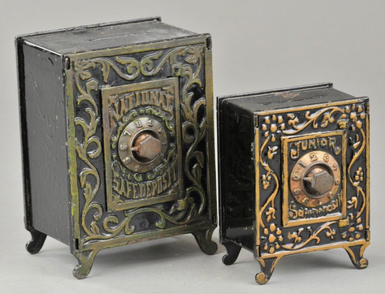 TWO SAFE VAULT STILL BANKS: Cast iron vault safes with pressed steel money boxes, gold and bronze trimmed lettering, each with combination dial door, includes Junior Safe Deposit and National Safe Deposit bank, both feature pede
