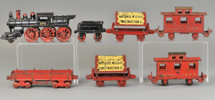KENTON ORE CARS FLOOR TRAIN SET: c. early 1900's, set includes #600 camel back locomotive in black, tender, two "National Railway Construction Co.," ore cars, gondola and LS&MS caboose with an added LS&MS caboose in red, green roof.