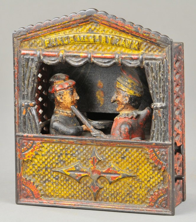 PUNCH & JUDY MECHANICAL BANK (SMALL LETTERS): Shepard Hardware Co., designed by Peter Adams & Charles Shepard, patented 7/15/1884. Judy receives the coin in the plate, the thumb piece at the side is pressed upon and Punch rushes forward brandishi