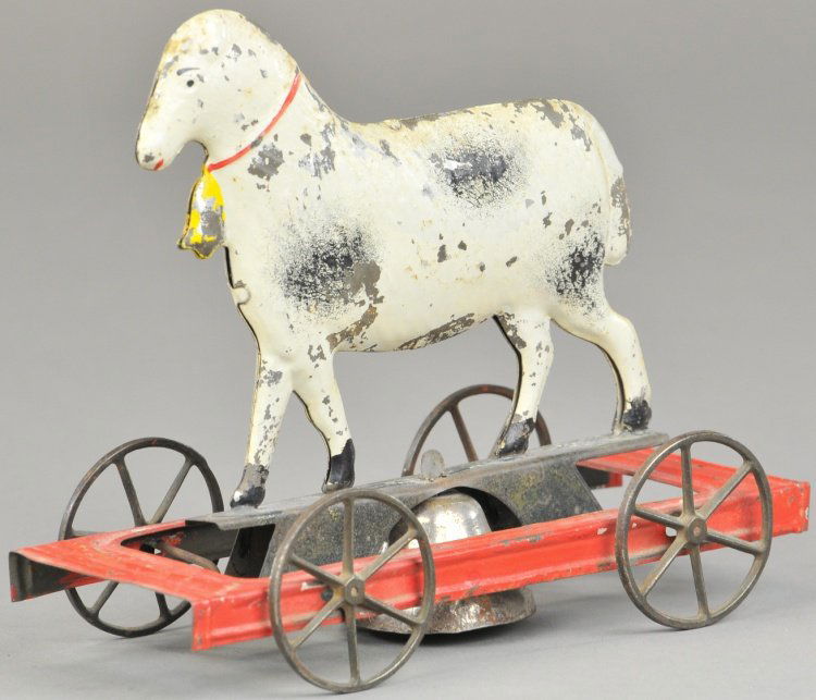 LAMB ON PLATFORM: Fallows, c. 1870's, hand painted tin, lamb done in white and grey, spoke wheel platform contains bell. 7 3/4" l.