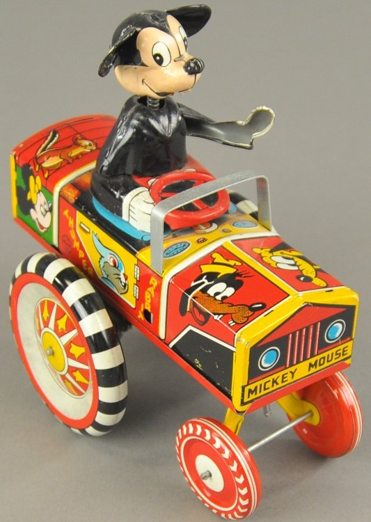 MICKEY MOUSE DIPSY CAR: Linemar, Japan, lithographed tin, very colorful, spring neck Mickey seated in open car, large disc wheels, key wind operated. 5 1/2" l.