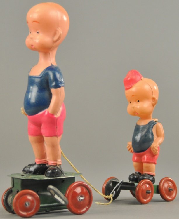 HENRY & HIS BROTHER WIND-UP: Copy. Carl Anderson, pre-war Japanese celluloid figures, depicts both figures standing on tin wheeled platforms, Henry has key wind in base. 6 1/2" h.