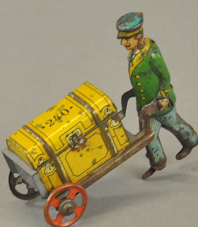 PORTER WITH LUGGAGE PENNY TOY: Fischer, Germany, lithographed tin, full figure of porter pushing hand cart containing suitcase. 3 1/4" l.