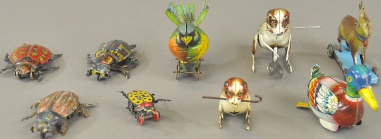 GROUPING OF ANIMAL PENNY TOYS: Germany and U.S. Zone Germany examples, lithographed tin, includes wind-up dogs and duck, bird on wheeled platform, rabbit on wheeled base and four beetle toys. 1 3/4" - 4 1/4" l.