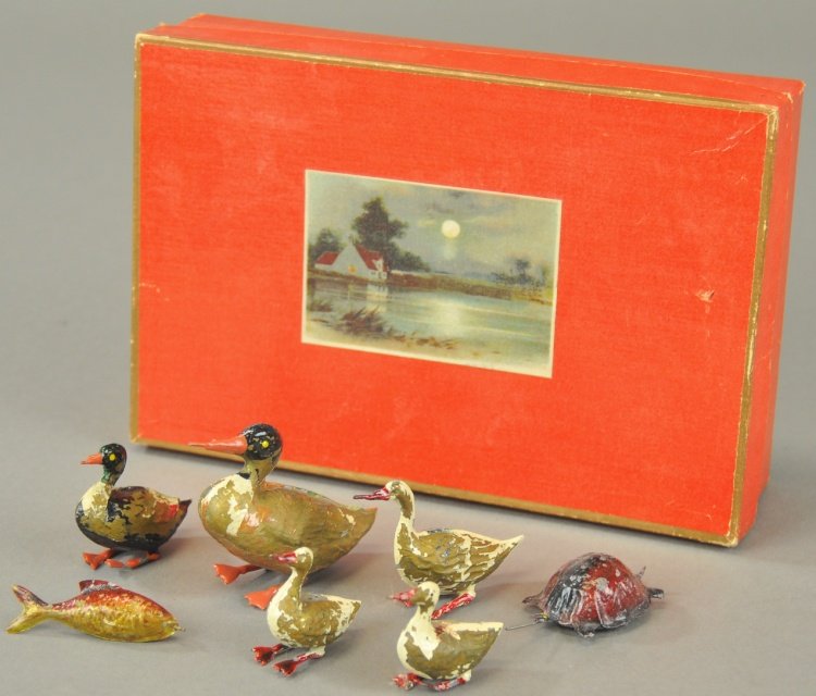 BOXED TIN TUB TOYS: Germany, hand painted tin example, very early set includes fowl, fish and turtle, all contained in original box with pond scene on lid, these could have been used in small swimming areas as well. 1 1/