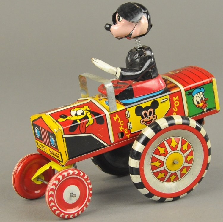 MICKEY MOUSE DIPSY CAR: Linemar, Japan, lithographed tin, very colorful, spring neck Mickey seated in open car, large disc wheels, key wind operated. 5 1/2" l.