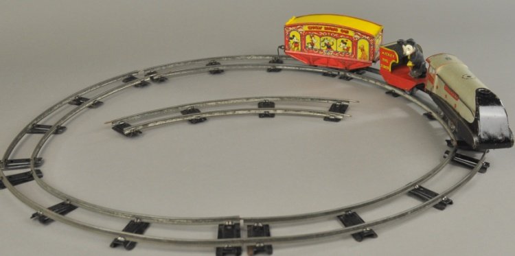 WALT DISNEY MICKEY MOUSE CIRCUS TRAIN: Wells, England, permission Walt Disney Mickey Mouse, Ltd., tin lithographed wind-up toy train, includes a silver link engine, Mickey the Stoker tender and Mickey Mouse circus car with extensive graphi