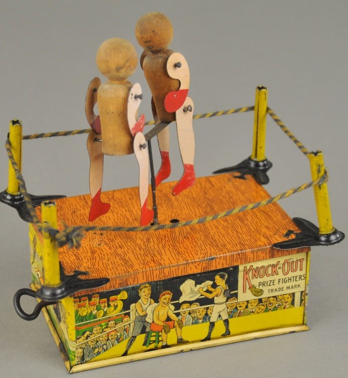 KNOCK-OUT BOXERS: Ferdinand Strauss, lithographed tin, detailed toy depicts boxing ring with two battling boxers at center, key wind operated. 5 1/2" h.