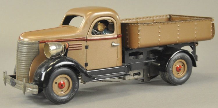 VEBE DUMP TRUCK: France, tinplate toy done in bronze body, electric lights, clockwork driven, opening doors and lift gate, rubber tires, seated composition driver. 12 1/2" l.