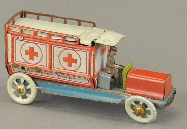 PENNY TOY AMBULANCE: Lithographed tin, ambulance depicts panel van body with solo driver, marked "Sanitats-Korps" with red crosses on sides. 3 1/2" l.