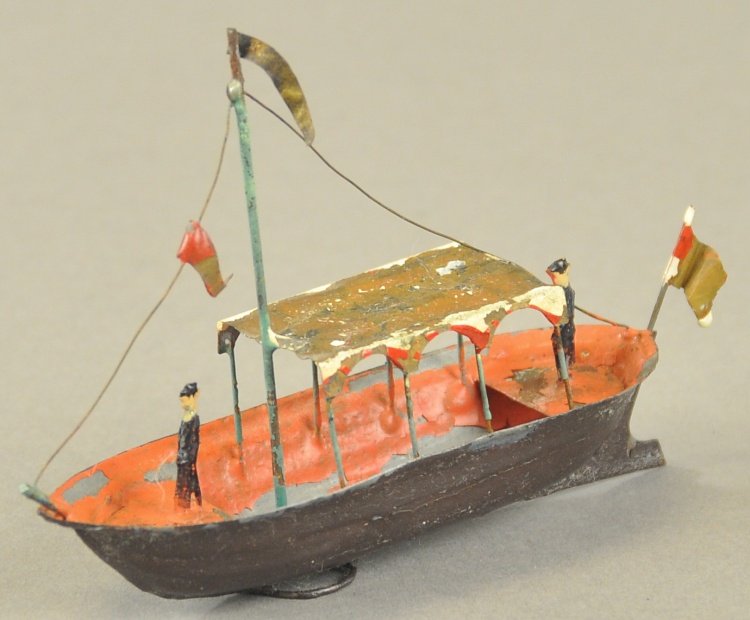 ISSMAYER LAUNCH: Germany, c. mid 1800's, hand painted overall, features soldier at bow and stern, canopy cover over center deck, tall pole mast with rigging, flag at stern. 4" l.