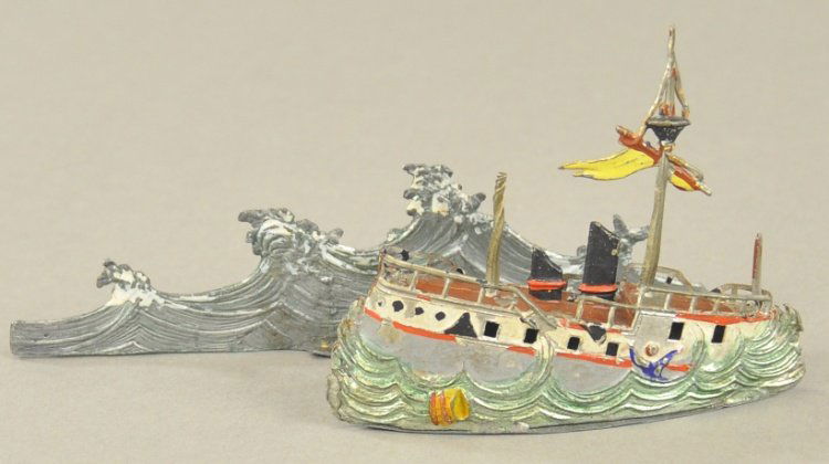 SINKING STEAM SHIP AT SEA: Heyde, Germany, early lead example, hand painted, good detail to tall waves along sides, two stack ship appears to be sinking, sailor embossed grasping the hull on sides, includes long wave display. 3