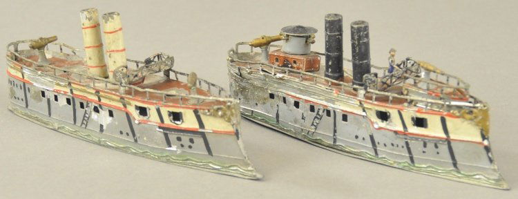 LOT OF TWO GERMAN WARSHIPS: Heyde, Germany, hand painted lead ships, each with two stacks, railed deck, observation platforms, guns on board, painted grey and white hulls. 6 1/4" l.