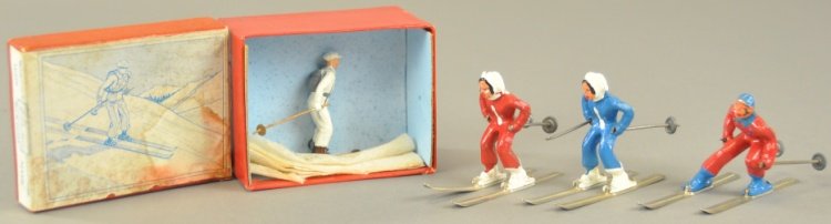 SKI TROOPERS WITH ONE BOX: Set #2037 contained with original illustrated box, together with three varied ski troopers in red, blue and white outfits, not from Britain's set, post war examples. Box 4" w. Figure 2 1/4" h.