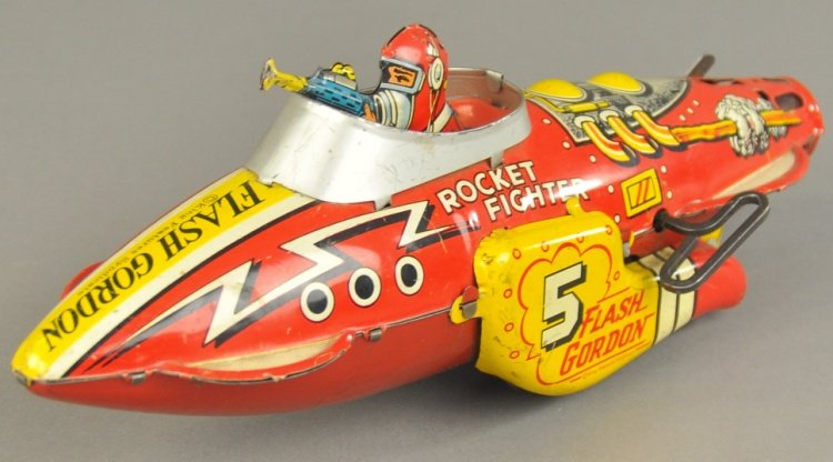 FLASH GORDON ROCKET FIGHTER: Marx, lithographed tin, seated fighter pilot, nice graphics overall, bright yellow side fins, key wind driven, lacks sparking action. 12" l.
