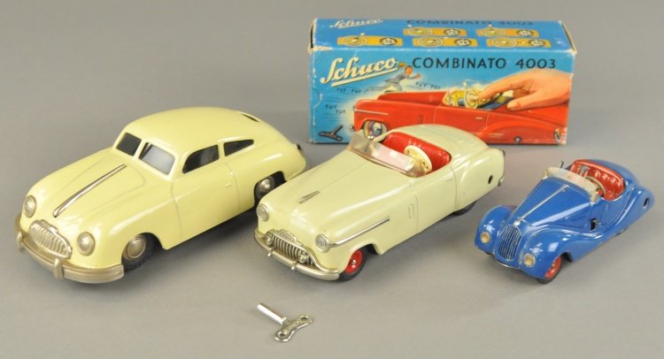SCHUCO & SIX-MOBIL AUTO GROUP: Lot includes No. 557 Six-Mobil sedan in cream color, Schuco boxed 4003 convertible and Schuco Examino 4001 convertible in blue, all clockwork driven. 5 1/2" to 8 1/2" l.