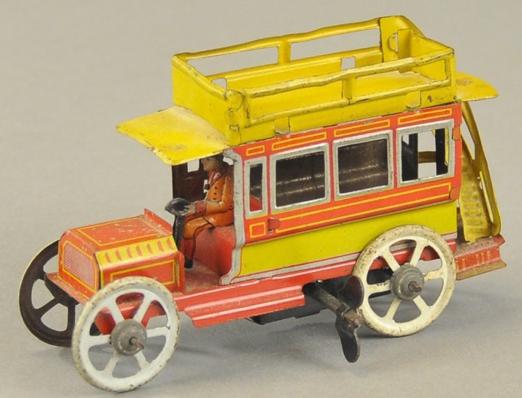 OMNIBUS PENNY TOY: Attributed to Distler, clockwork operation, seated driver, red and yellow paint pattern with grey window trim and wheels, rear stairway to upper deck, clockwork driven. 4 1/4" l.