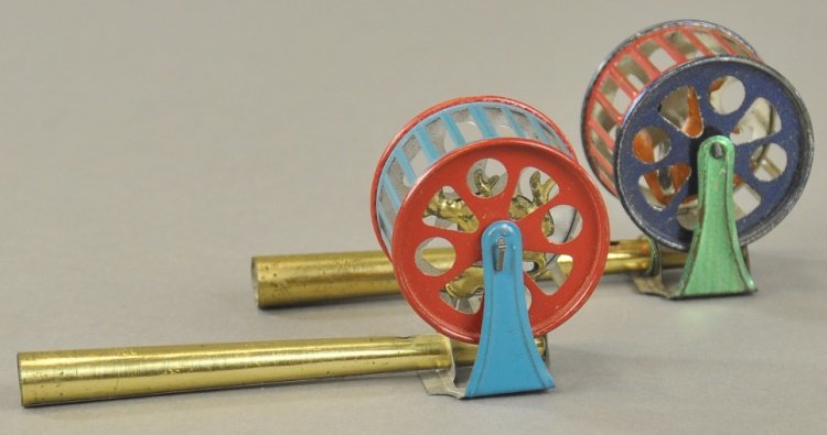 LOT OF PENNY TOYS: Includes two squirrel in cage whistles, done in gold finished pipes with blue, green and red cages containing tin litho squirrels. 4 1/2" h.