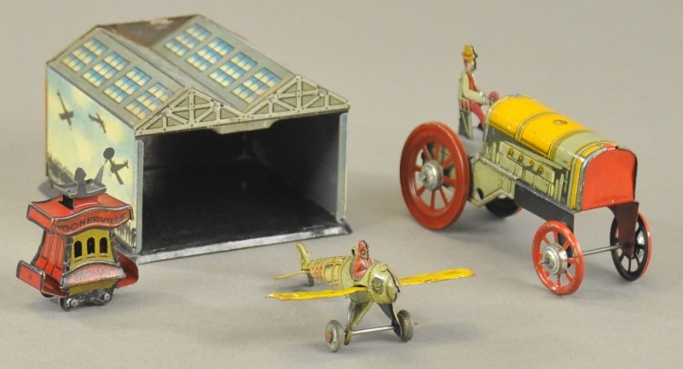 GROUPING OF PENNY TOYS: Assorted tin litho lot includes airplane with hangar, Cracker jack Toonerville Trolley and farm tractor with driver. 1 3/4" h. - 3" l.
