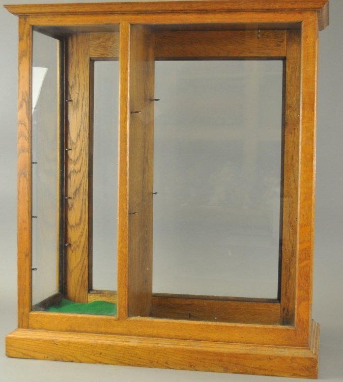 PARTITIONED OAK & GLASS DISPLAY CASE: Rear entry oak display case with partition and screw eyes for shelves. 29" h.