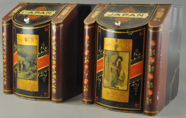 TWO EARLY TIN LITHO TEA BINS: Two store counter tops, Japan tea bins, impressive decorations on both and each with a Victorian lithograph scene on the front, lift knobs may not be original, some light wear to both. 18" h.