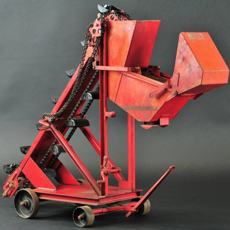 BUDDY 'L' SAND SCREENER: c. 1927-1930, pressed steel, painted in red overall with black buckets, features screening hoppers and chute. 29" x 17" x 21".
