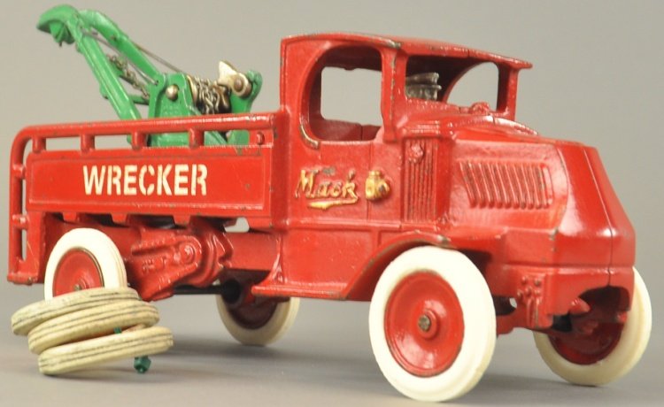 MACK WRECKER: Arcade, cast iron body stenciled "Wrecker" on sides, painted in red with green Weaver crane on railed open body, nickel disc wheels have red painted centers, nickel plated driver. 12" l.