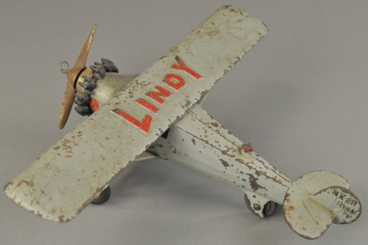 HUBLEY "LINDY" AIRPLANE: Cast iron, painted in grey overall, nice detail to frame support, red lettering embossed "Lindy" on wing, rubber tires, nickel single propeller "Spirit of St. Louis" on top fuselage, black cast motor.