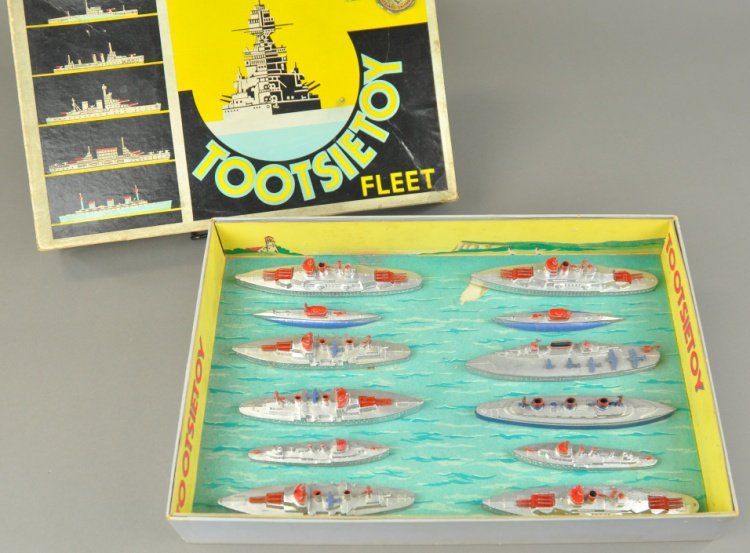 BOXED TOOTSIETOY FLEET MILITARY NO. 5700 SET: Includes eleven Navy ships, featuring cruisers, battleships, carriers and submarines. Box 16" x 15".